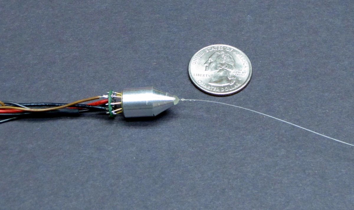 A miniature interrogation module that fits in a TO header (top) uses a position-sensitive detector and a linear variable filter to resolve tiny wavelength changes. In a vibration experiment (bottom), wavelength changes as small as 50 fm are detected.