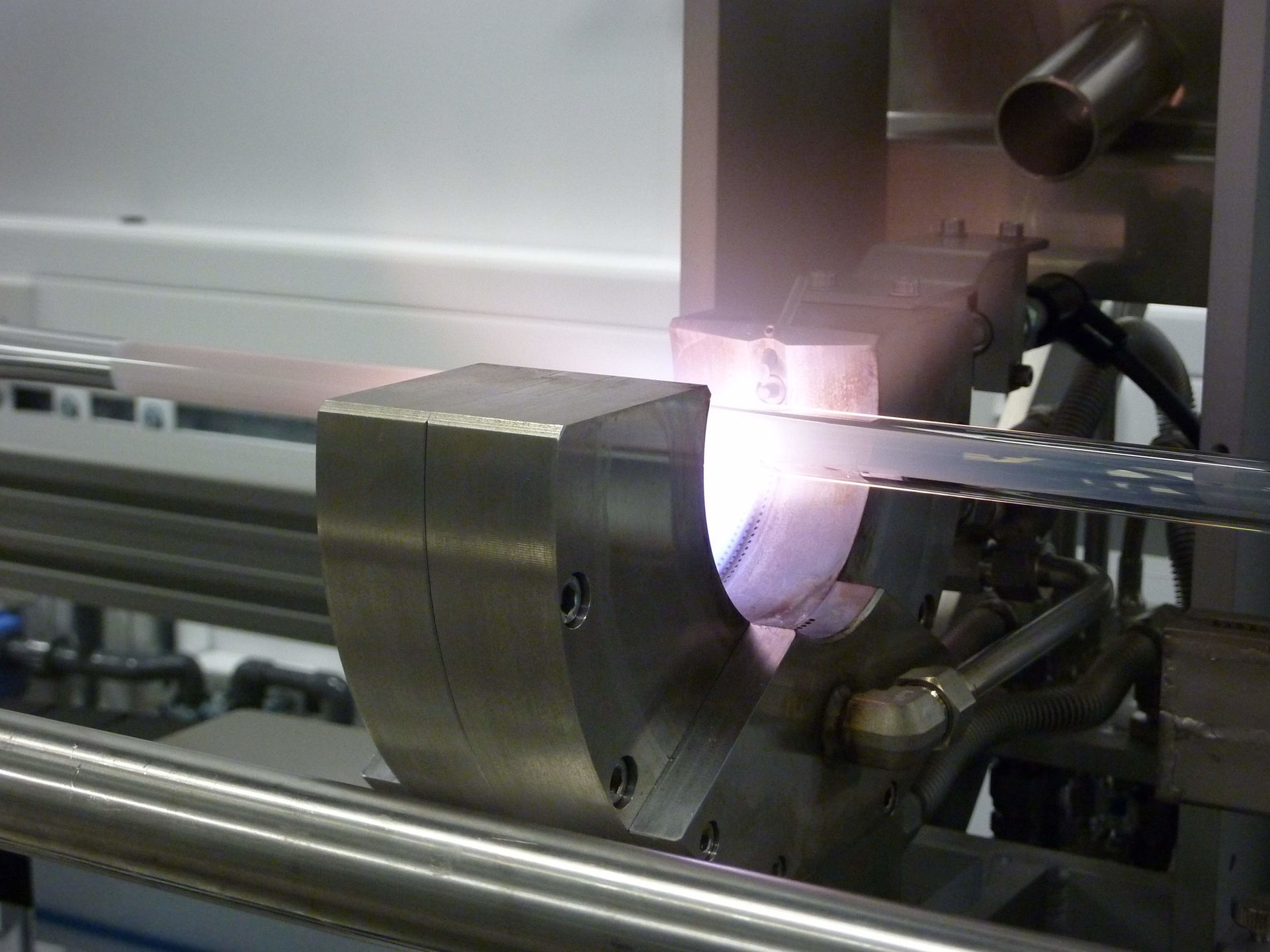 FIGURE 1. Modified chemical-vapor deposition (MCVD) equipment for preform fabrication shows the deposition of a porous silica soot layer.