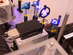 FIGURE 1. The 355-nm Cobolt Zouk laser in a total internal reflection fluorescence (TIRF) microscopy setup. Zouk is a single-mode DPSS laser offering 10 mW CW in a 5 × 2.8 × 1.8-in. hermetically sealed package, with very low-intensity noise, and in a high-quality TEM00-mode and low-divergent beam. FIGURE 1. The 355-nm Cobolt Zouk laser in a total internal reflection fluorescence (TIRF) microscopy setup. Zouk is a single-mode DPSS laser offering 10 mW CW in a 5 × 2.8 × 1.8-in. hermetically sealed package, with very low-intensity noise, and in a high-quality TEM00-mode and low-divergent beam.