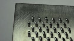 FRONTIS. In aerospace component drilling tests, a single 10 ms pulse from a square output fiber laser can produce a large square entrance hole at focus.