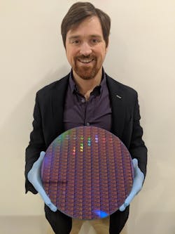 Dr. Chad Husko, CEO and founder of Iris Light, holds a 300 mm silicon wafer. Dr. Chad Husko, CEO and founder of Iris Light, holds a 300 mm silicon wafer.