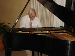 Angus playing piano at the Topical Meeting on Optical Interference Coatings, Tucson, 2007.