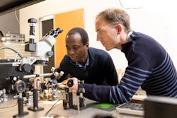 Researchers Boubacar Kant&eacute; and Thomas Lepetit examine their BIC-producing apparatus.