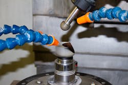 FIGURE 2. Ball tools were used to rough and fine-grind this ellipsoid surface. Before processing, the surface was covered with a black marker. This is common when grinding and polishing optics to ensure consistent material removal across the surface. FIGURE 2. Ball tools were used to rough and fine-grind this ellipsoid surface. Before processing, the surface was covered with a black marker. This is common when grinding and polishing optics to ensure consistent material removal across the surface.