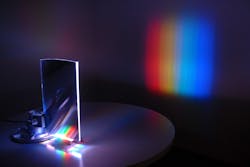 A wedge-shaped waveguiding optic directs light from nine discrete red, green, and blue LEDs into a planar, collimated beam for a high-efficiency display backlight, and for numerous other potential applications.
