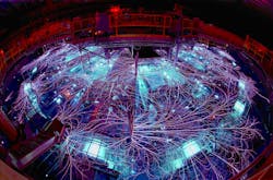 FIGURE 1. Huge electrical currents generate arcs and sparks on the Z machine at Sandia National Labs. The bright objects in the foreground are the laser triggered gas switches. FIGURE 1. Huge electrical currents generate arcs and sparks on the Z machine at Sandia National Labs. The bright objects in the foreground are the laser triggered gas switches.