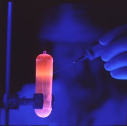 Purified DNA, fluorescing orange under UV light. Purified DNA, fluorescing orange under UV light.