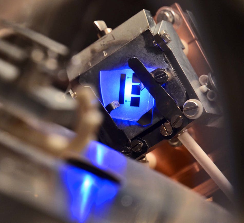 An LED emitting light under forward bias in an ultrahigh-vacuum chamber shows simultaneous electron-emission energy.