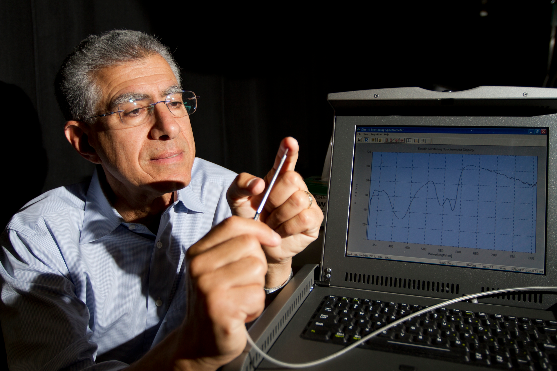 Irving Bigio, professor at BU Biomedical Engineering and Electrical & Computer Engineering, with the fiber-optic probe used for early colorectal cancer detection.