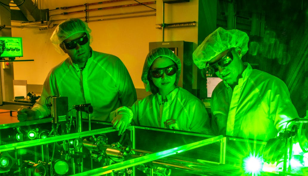 Berkeley Lab doctoral student Fumika Isono (center), BELLA Center Deputy Director Jeroen van Tilborg (right), and research scientist Sam Barber set up a novel laser stabilization experiment at one of the BELLA Center&rsquo;s 100 TW-class lasers.