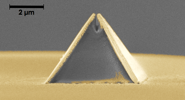 A new process called fiber nanoimprinting speeds fabrication of nanooptical devices, such as this pyramid-shaped Campanile probe imprinted on an optical fiber (captured in a scanning electron microscope image). The gold layer is added after imprinting and the gap at the top is 70 nm wide.