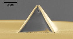 A new process called fiber nanoimprinting speeds fabrication of nanooptical devices, such as this pyramid-shaped Campanile probe imprinted on an optical fiber (captured in a scanning electron microscope image). The gold layer is added after imprinting and the gap at the top is 70 nm wide.