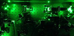 An image from an experiment in the quantum optics laboratory at the University of Cambridge demonstrates how laser light was used to excite artificially constructed atoms known as quantum dots to create the &ldquo;squeezed&rdquo; single photons.