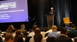 FIGURE 1. Conard Holton, Editor in Chief of Laser Focus World, kicks off the 30th Lasers & Photonics Marketplace Seminar, thanking sponsors and introducing the agenda for the day; the Seminar attracted a record number of attendees to take advantage of a banner time in lasers and photonics.