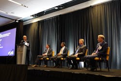 FIGURE 6. Members of the Executive Panel focused on technology trends in lasers and on the roles of acquisitions and organic growth. From left to right, Martin Seifert (Booz Allen Hamilton; standing), Basil Garabet (NKT Photonics), Sri Venkat (Coherent), Dave Allen (MKS/Spectra-Physics), and Berthold Schmidt (Trumpf).