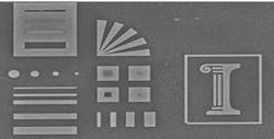 A glass stamp reproduces precise, nanometer-scale etchings in silver. The original engraving is 10 microns wide. A glass stamp reproduces precise, nanometer-scale etchings in silver. The original engraving is 10 microns wide.