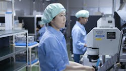 FIGURE 2. Olympus technicians inspect the wavefront aberration of microscope objective lenses. FIGURE 2. Olympus technicians inspect the wavefront aberration of microscope objective lenses.