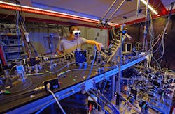 FIGURE 2. Tobias Frank, a Ph.D. candidate in Professor Gerhard Rempe’s Quantum Dynamics group at MPQ, prepares a single ultracold atom to be placed inside the crossed resonator setup. FIGURE 2. Tobias Frank, a Ph.D. candidate in Professor Gerhard Rempe’s Quantum Dynamics group at MPQ, prepares a single ultracold atom to be placed inside the crossed resonator setup.