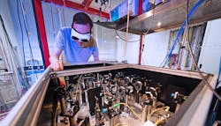 FIGURE 4. Maximilian Löw, a Ph.D. candidate in Professor Gerhard Rempe’s Quantum Dynamics group at MPQ, distributes the frequency comb light needed to stabilize all lasers in the group’s various laboratories. FIGURE 4. Maximilian Löw, a Ph.D. candidate in Professor Gerhard Rempe’s Quantum Dynamics group at MPQ, distributes the frequency comb light needed to stabilize all lasers in the group’s various laboratories.