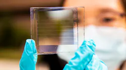Xinjing Huang, a doctoral student in Forrest’s lab, holds a 20% transparency, 30-year solar cell module that she built. The longevity of the design is a major step toward practical windows that provide solar power.