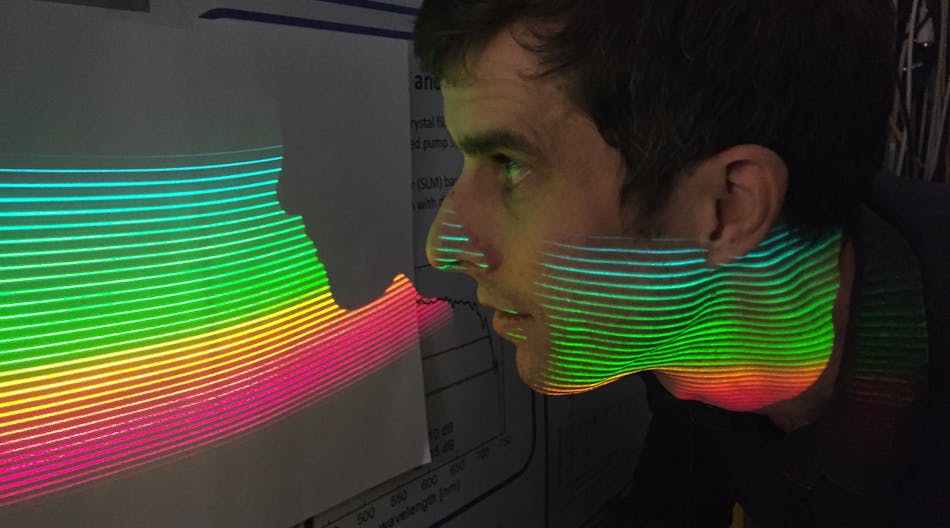 Tilo Steinmetz, Menlo&apos;s AstroComb product manager, inspects comb modes of the ESPRESSO-AstroComb projected onto a screen by means of an echelle spectrograph.