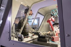 A student in the Optical Systems Technology program at Monroe Community College learns to operate the Moore Nanotechnology Systems 250 UPL diamond-turning machine. A student in the Optical Systems Technology program at Monroe Community College learns to operate the Moore Nanotechnology Systems 250 UPL diamond-turning machine.