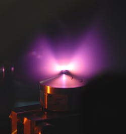 Helium atoms flowing from a small nozzle are ionized by a laser pulse, forming a plasma channel from helium ions and free electrons. In this channel, the flash of light accelerates a small portion of the electrons almost to the speed of light. Helium atoms flowing from a small nozzle are ionized by a laser pulse, forming a plasma channel from helium ions and free electrons. In this channel, the flash of light accelerates a small portion of the electrons almost to the speed of light.