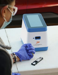 The LightDeck Analyzer and cartridge are shown. The LightDeck Analyzer and cartridge are shown.
