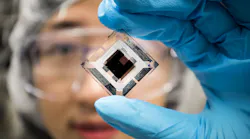 Xiaozhou Che, EECS Graduate Research Assistant at the University of Michigan, holds an organic tandem photovoltaic cell in the EECS Building on April 20, 2018.