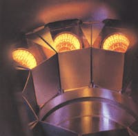 FIGURE 1. Glowing coils are heaters in a molecular-beam-epitaxy (MBE) deposition system. Elements for deposition are vaporized in crucibles above the heaters and sprayed onto the target device. FIGURE 1. Glowing coils are heaters in a molecular-beam-epitaxy (MBE) deposition system. Elements for deposition are vaporized in crucibles above the heaters and sprayed onto the target device.
