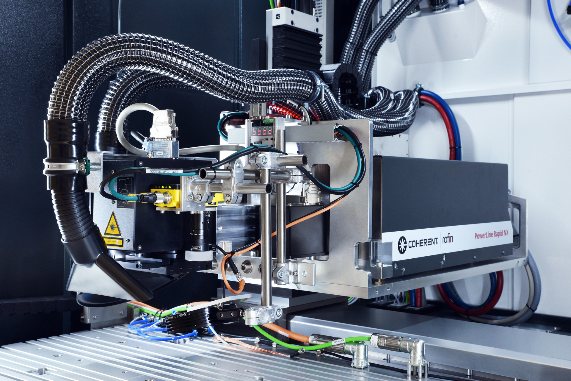 FIGURE 3. A commonly specified subsystem type incorporates an ultrafast laser (the Coherent Powerline Rapid NX) and rail-mounted beam delivery, as well as focusing and scanning optics.