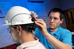 Jason B. Forsyth places a wearable pulse oximetry computing system on a helmet to protect construction workers from carbon monoxide poisoning. The work garnered the Virginia Tech researchers a Best Paper award. Jason B. Forsyth places a wearable pulse oximetry computing system on a helmet to protect construction workers from carbon monoxide poisoning. The work garnered the Virginia Tech researchers a Best Paper award.