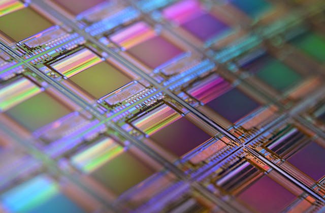 FIGURE 1. On a silicon wafer, each square is a chip with microscopic transistors and circuits. Ordinarily, wafers like these are diced into their individual chips and the chips go into the processors that power our smart technology devices.