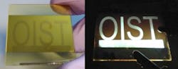 A large perovskite-based LED produced using chemical vapor deposition is connected to a 5 V current, illuminating an OIST pattern etched on the surface.