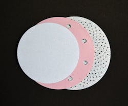 FIGURE 2. Three abrasive discs illustrate the progression from no holes, to 10mm-diameter holes, to high-density, 1.5mm-diameter micro-holes for dust extraction. FIGURE 2. Three abrasive discs illustrate the progression from no holes, to 10mm-diameter holes, to high-density, 1.5mm-diameter micro-holes for dust extraction.