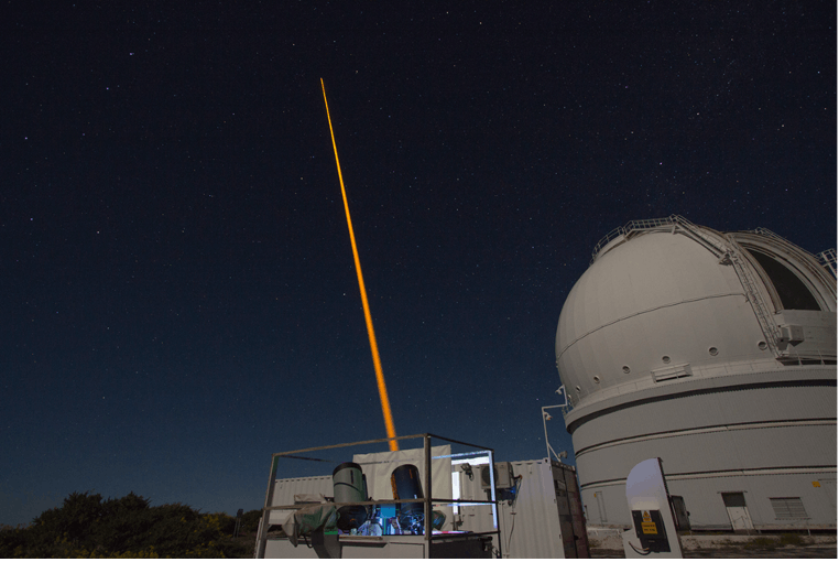 The laser-guide-star magnetometry experiment at the site of the William Herschel Telescope (right) at La Palma. Two detection telescopes are seen at the foreground.