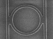 Microring resonator with fused waveguides has a radius of 3 &micro;m and was fabricated at Hewlett Packard. Resonators with radii of 3 to 5 &micro;m that resonate with Qs of 250 were observed at a wavelength of 1.55 &micro;m.