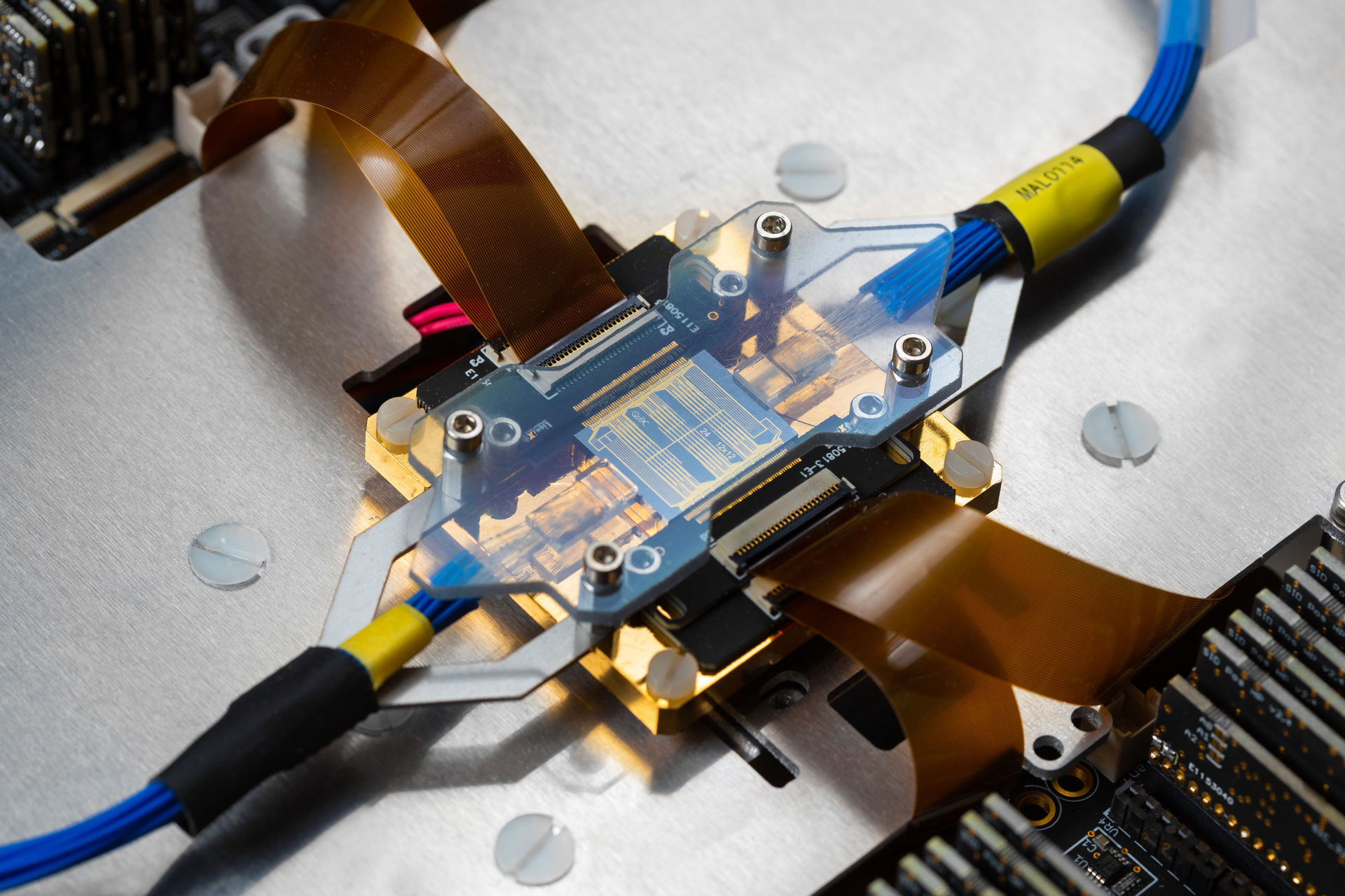 FIGURE 1. Photonic assembly of the 12-mode universal quantum photonic processor. The photonic integrated circuit (PIC) is optically and electrically interfaced&mdash;featuring more than 150 tuning elements for full programmability.