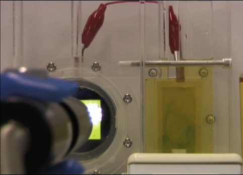 In Panasonic's artificial photosynthesis system (nitride semiconductor on left, metal catalyst on right), the change of color from yellow to blue in the catalyst indicates that the system is reducing carbon dioxide.