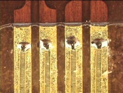 FIGURE 5. A 0.008-in.-thick copper flat wire welded to 0.008-in.-thick copper lead frame coated. FIGURE 5. A 0.008-in.-thick copper flat wire welded to 0.008-in.-thick copper lead frame coated.