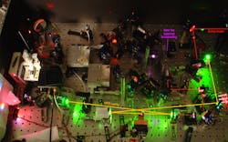 Part of a frequency comb instrument used to measure trace gases for biomedical applications, the beam from a powerful fiber laser is converted by a special crystal and other optics into two light waves at lower frequencies. The system can detect and measure the concentration of many different molecules based on how they absorb light in the mid-infrared region of the electromagnetic spectrum. Part of a frequency comb instrument used to measure trace gases for biomedical applications, the beam from a powerful fiber laser is converted by a special crystal and other optics into two light waves at lower frequencies. The system can detect and measure the concentration of many different molecules based on how they absorb light in the mid-infrared region of the electromagnetic spectrum.