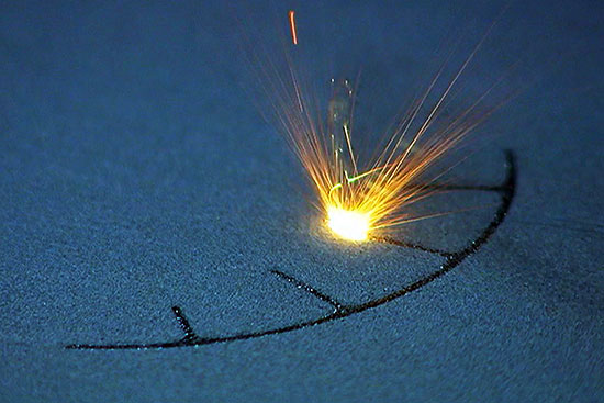 FIGURE 1. A laser fuses metal powder to form one of many successive layers that will form the final part.
