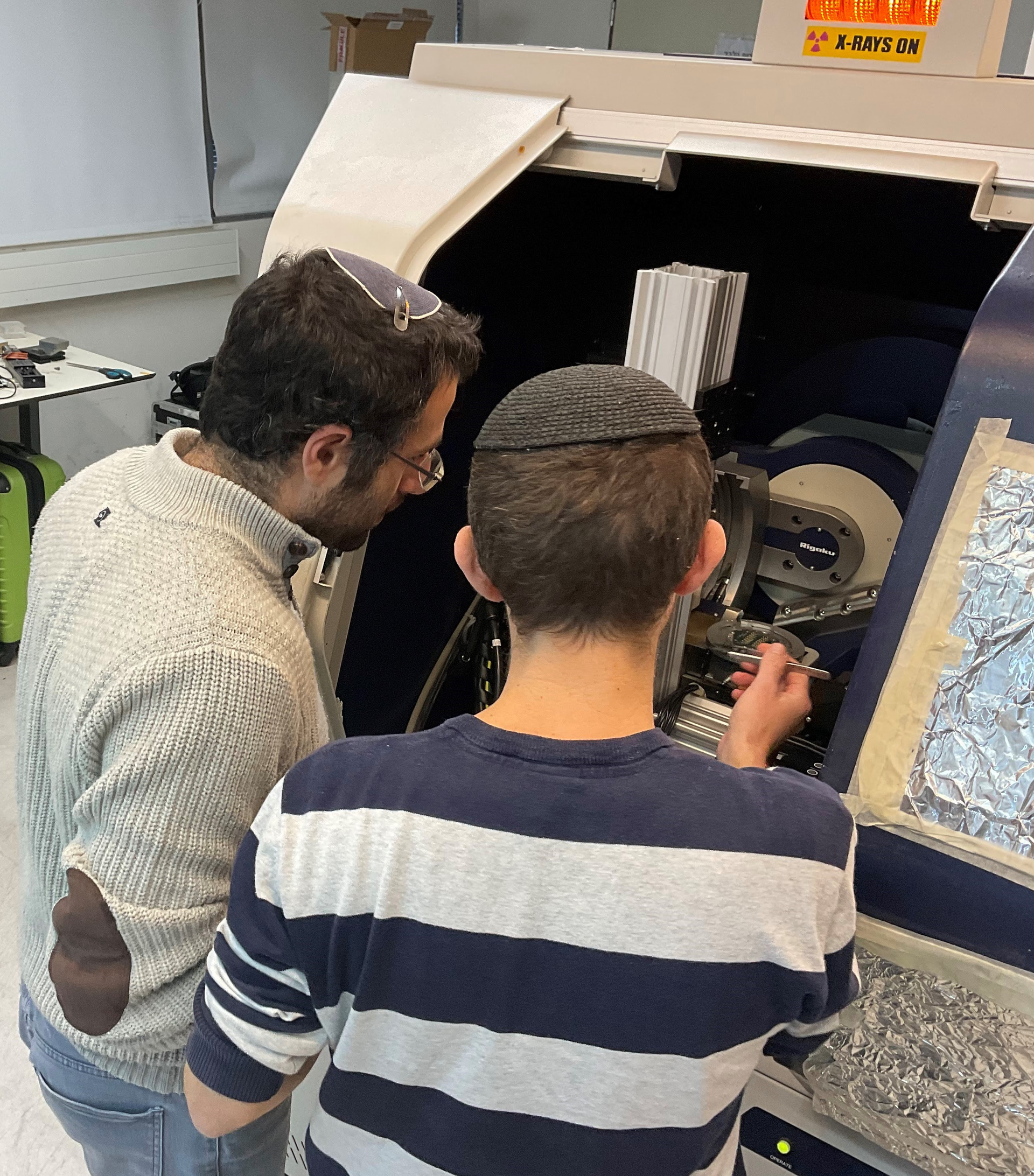 FIGURE 1. Yishay Klein and Or Sefi working on their x-ray computational ghost fluorescence experimental system.