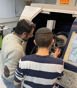 FIGURE 1. Yishay Klein and Or Sefi working on their x-ray computational ghost fluorescence experimental system. FIGURE 1. Yishay Klein and Or Sefi working on their x-ray computational ghost fluorescence experimental system.