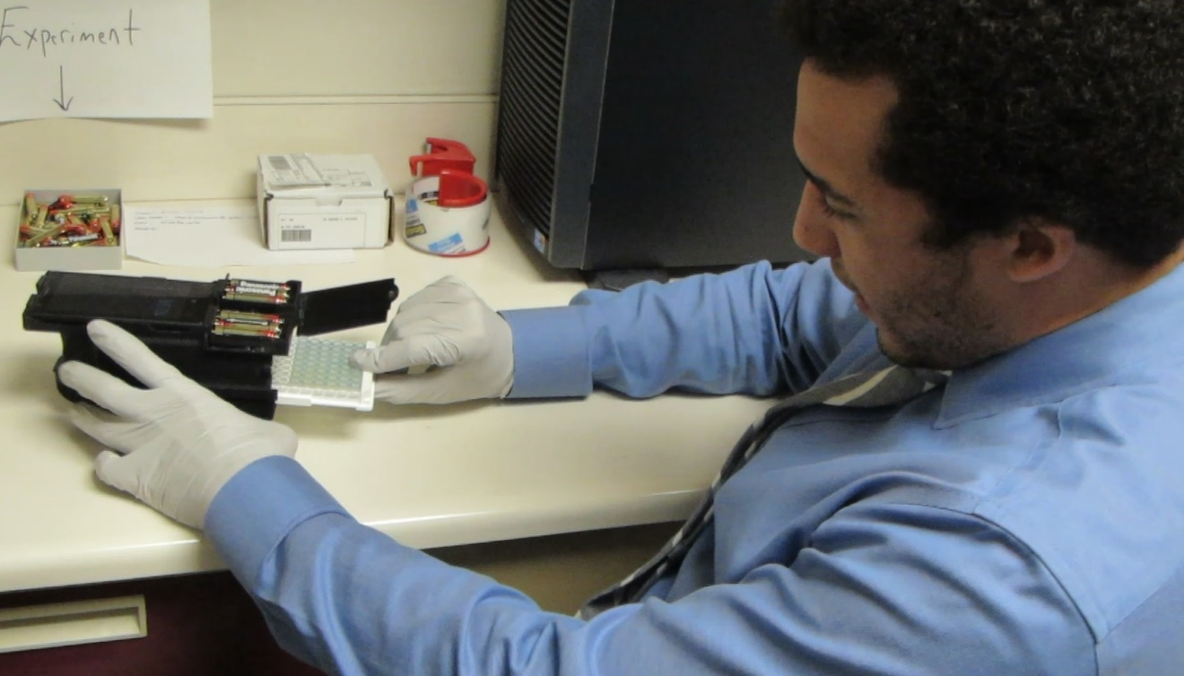 A researcher uses the mobile-phone ELISA platform.