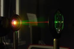 A laser beam is used in the lab to test the gold-hyperdoped sample of silicon to confirm its infrared-sensitive properties.