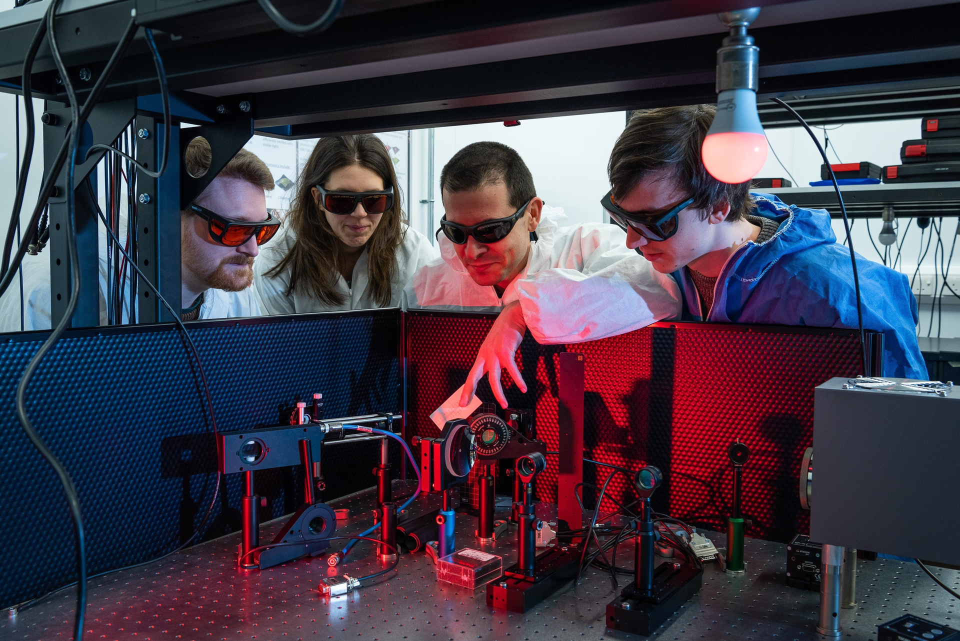 FIGURE 1. In 2019, Ventsislav Valev&rsquo;s team used a physical effect, the changing color of light scattered from chiral molecules, to measure the chirality present. L-R: David Hooper, Kristina Rusimova, Ventsislav Valev, and Joel Collins.