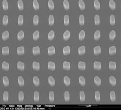 An electron microscopy image shows the nanostructure of the metasurface located at the center of the suspended silicon chip; the spacing from pillar to pillar is 835 nm, around 50 times thinner than a strand of hair. An electron microscopy image shows the nanostructure of the metasurface located at the center of the suspended silicon chip; the spacing from pillar to pillar is 835 nm, around 50 times thinner than a strand of hair.