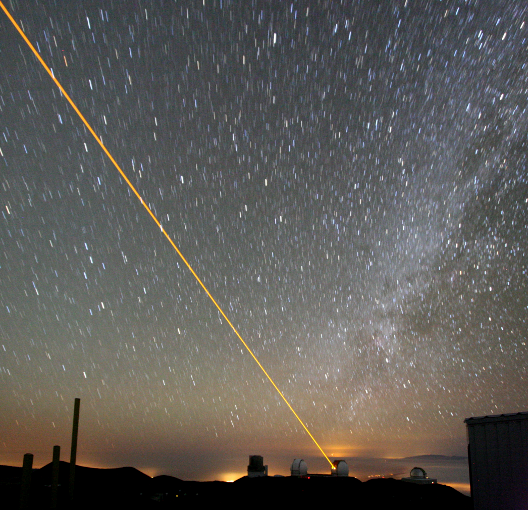 FIGURE 1. At the Keck Observatory in Hawaii, a laser beam is projected into the night sky to create a sodium beacon guide star.