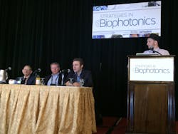 The final panel discussion at Strategies in Biophotonics, which focused on disruptive innovation and the future of biophotonics, highlighted the struggle that emerging technologies can face in addressing established standards. Left to right: Howard Shapiro, MD, Gary Tearney, MD, Ph.D., Aydogan Ozcan, Ph.D., and Dan Gareau, Ph.D. Tearney, who delivered a popular keynote at the event, will also speak at the Lasers and Photonics Marketplace Seminar on Monday, February 9, 2015, in San Francisco, CA.